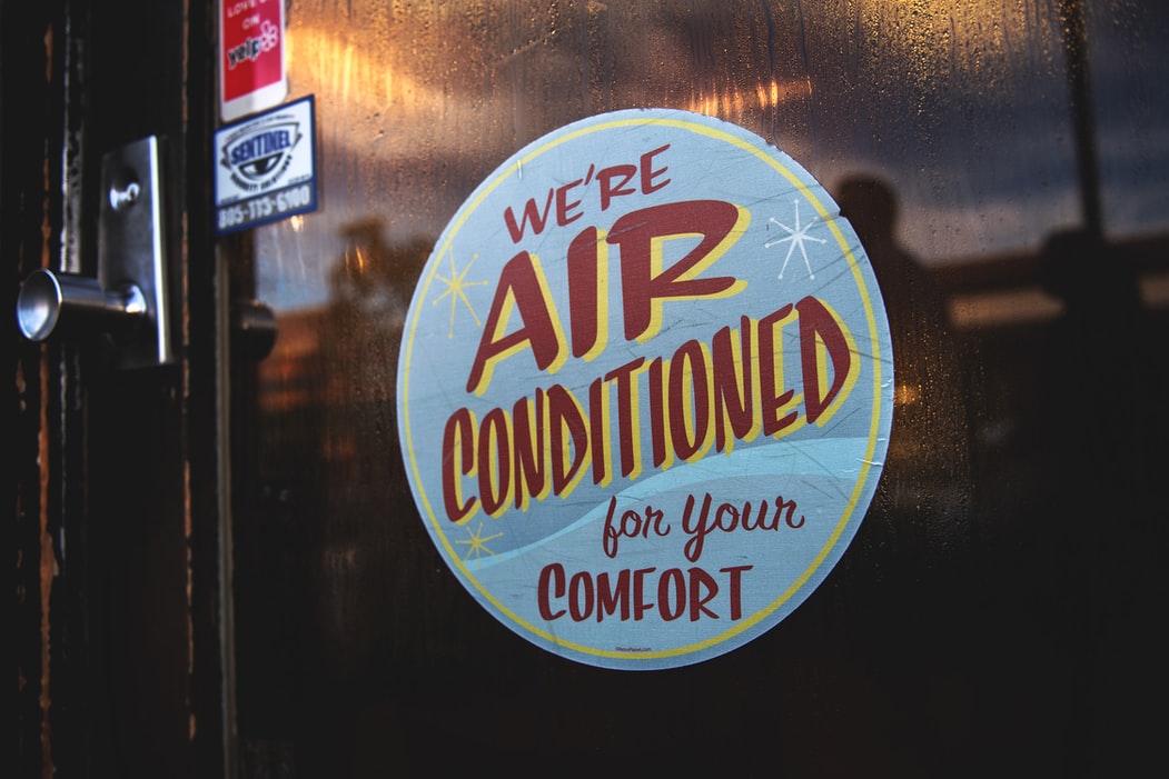 a sign that says "We're air conditioned for your comfort."